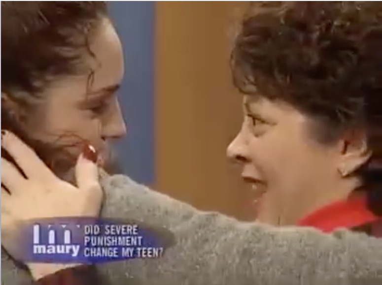 Kristen Settar touching mom Toni on the shoulder on the Maury Show, where she was featured as an out of control teen.