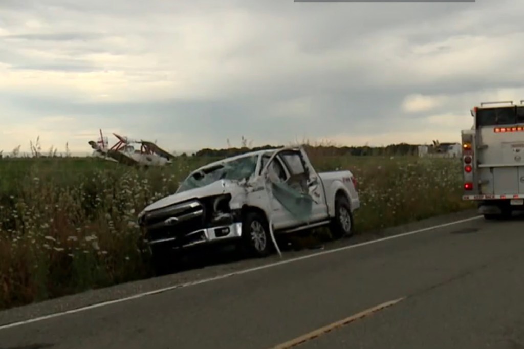 The plane left the car badly damaged but the driver was OK. 