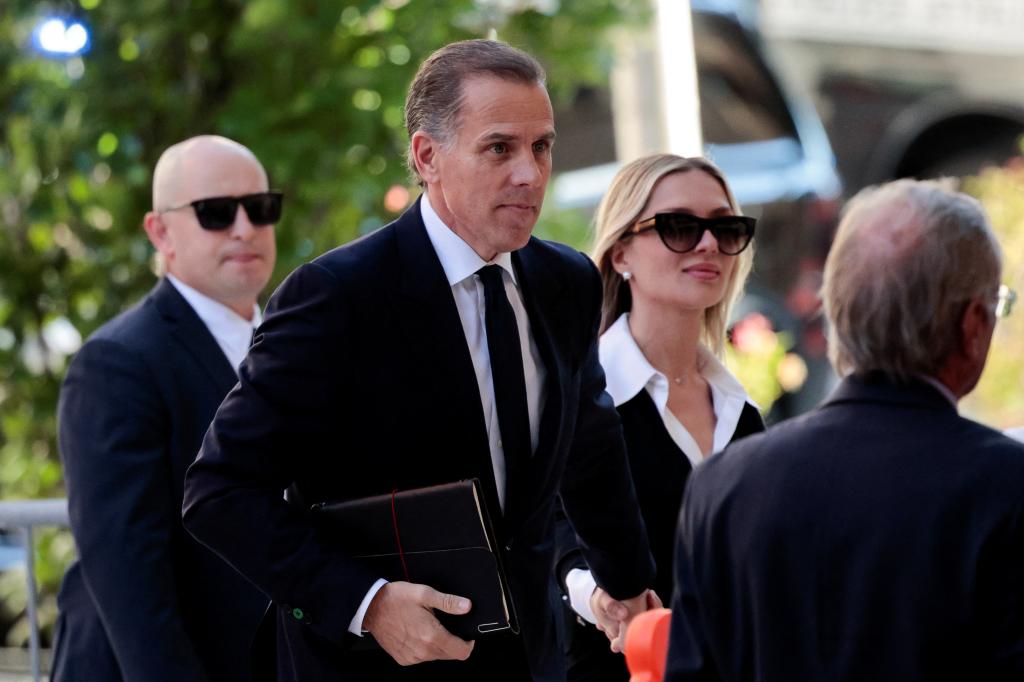 Hunter Biden in suit, holding a folder and arriving at federal court with his wife Melissa Cohen Biden, for his trial on criminal gun charges in Wilmington, Delaware.