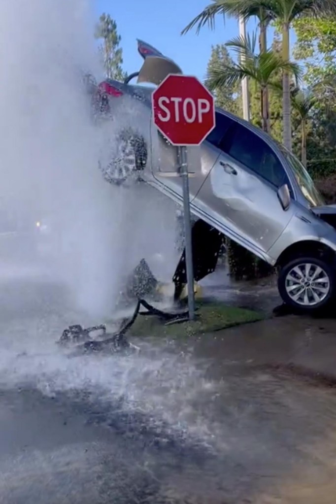 An SUV was suspended in the air after striking a fire hydrant in Lake Forest, California.