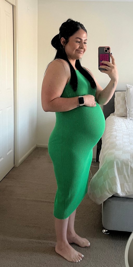 Pregnant woman Jenn Gutierrez in green dress, who experienced contractions during a Taylor Swift concert