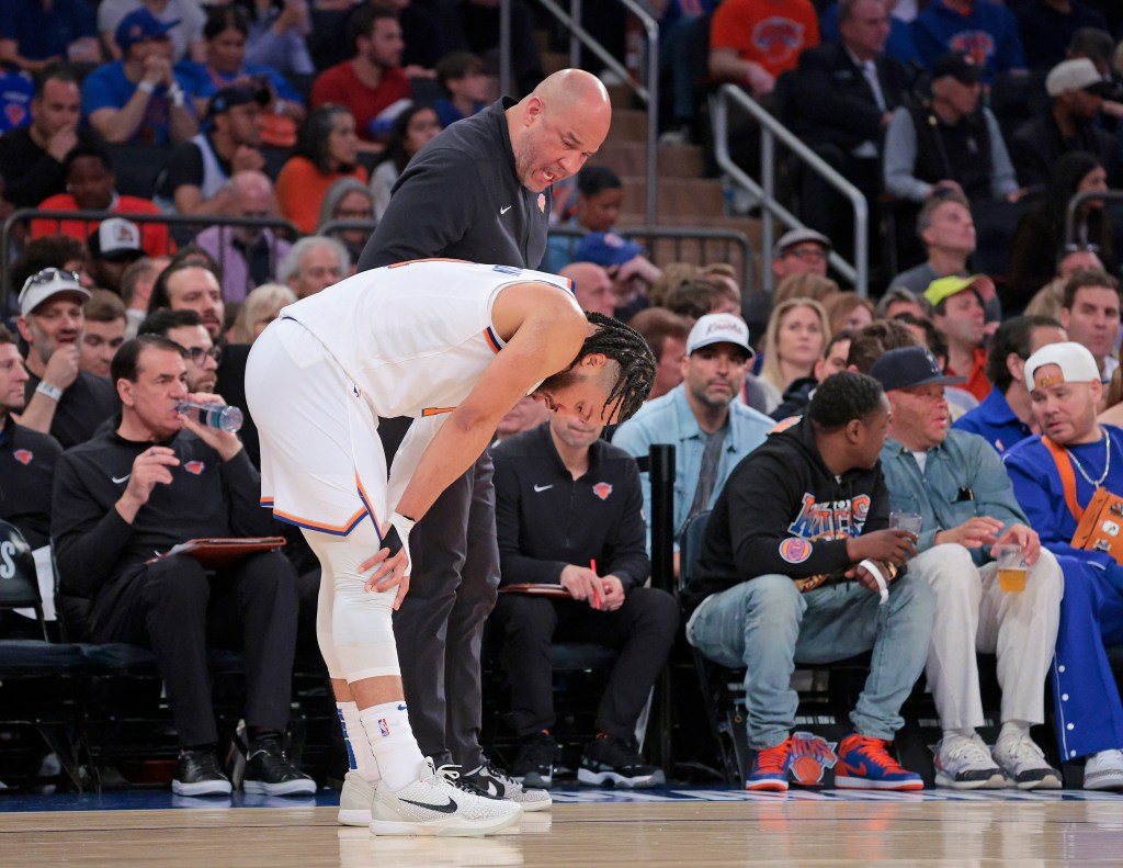 Jalen Brunson with his hands on his knees as he speaks to his dad, Knicks assistant Rick Brunson, during their Game 7 loss to the Pacers on May 19, 2024.