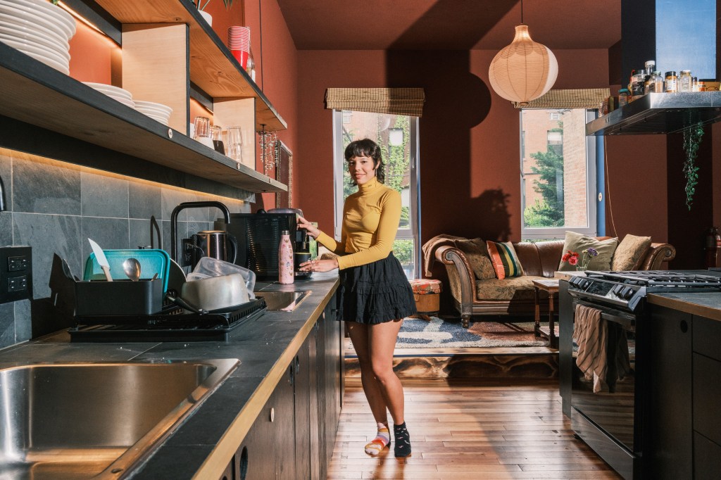 Isabel Antonioli, a tenant, prepares coffee in the main kitchen. 