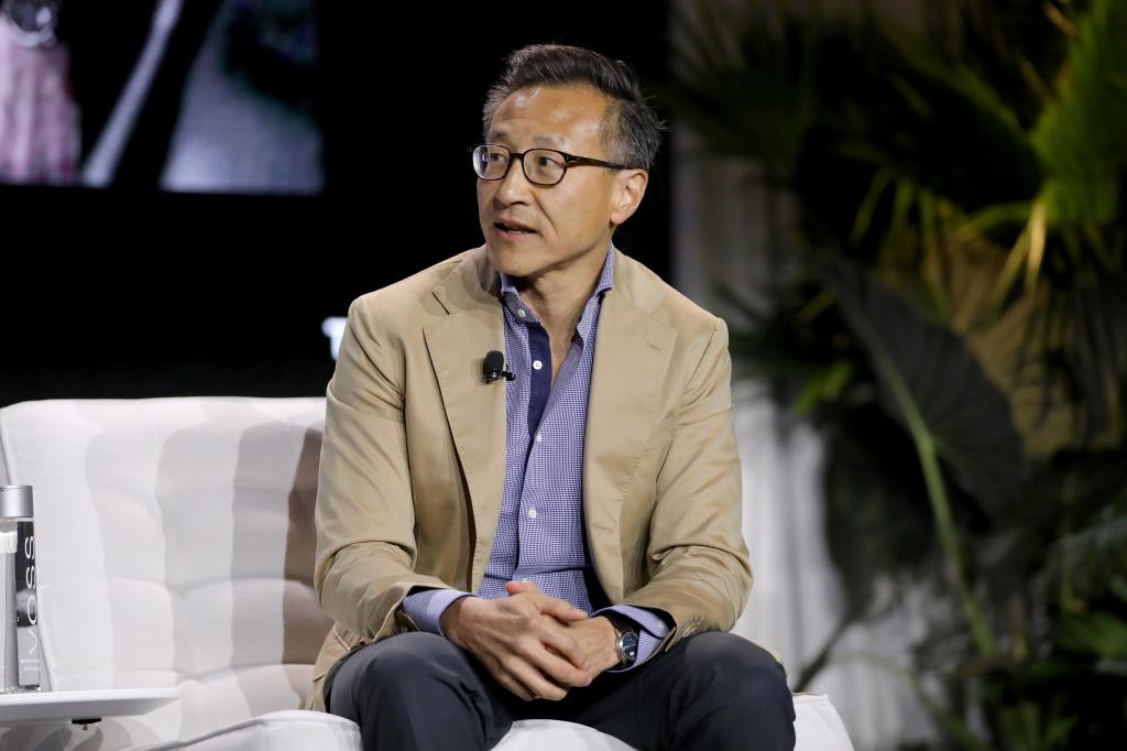 Jose Tsai sitting at a conference.