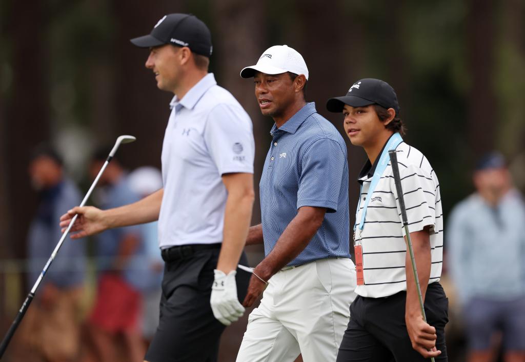 Tiger Woods (c.) and his son Charlie (r.) walk with Jordan Spieth (l.) on Monday.