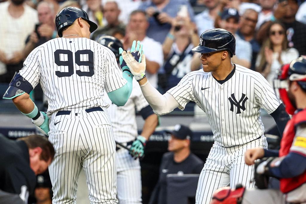 New York Yankees center fielder Aaron Judge (99) celebrates with right fielder Juan Soto (22) after hitting a two run home run against the Atlanta Braves in the first inning at Yankee Stadium. 