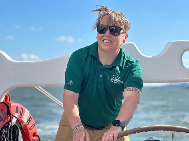 A woman wearing sunglasses and a green shirt, identified as Capt. Cait Field, at work on June 10, 2024