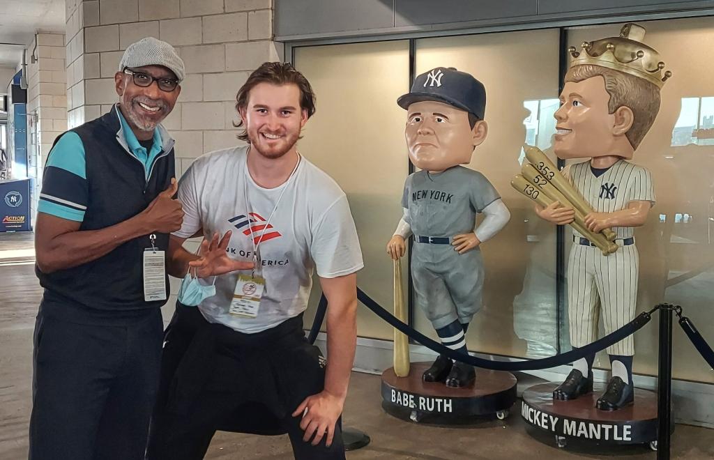 A man posing with a couple of men in front of a statue on June 10, 2024