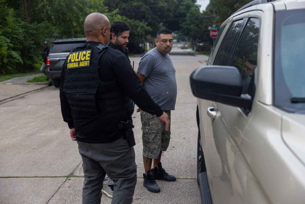 ICE officers take Rosvelt Arturo Sanchez Sanchez, 39, into their vehicle after arresting him in Houston, Texas.