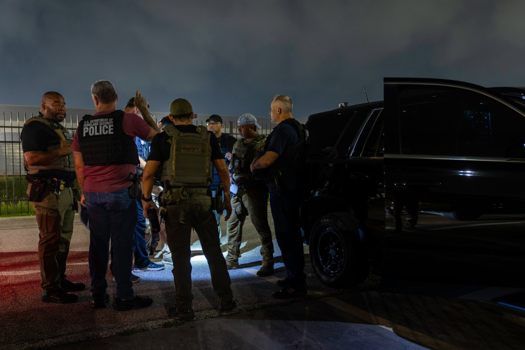 ICE officers gather before an early morning raid in Houston, Texas.