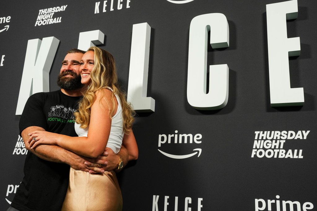 Jason Kelce and Kylie Kelce hugging at the Kelce documentary premiere in Philadelphia, Pennsylvania