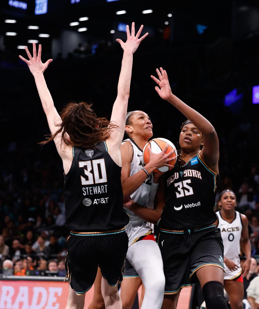 Breanna Stewart #30 and Jonquel Jones #35 defend against A'ja Wilson #22 of the Las Vegas Aces Game 3 of the 2023 WNBA Finals.