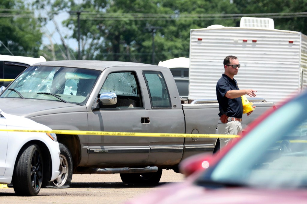 Law enforcement officers work the scene of a shooting at the Mad Butcher grocery store in Fordyce, Ark., Friday, June 21, 2024.