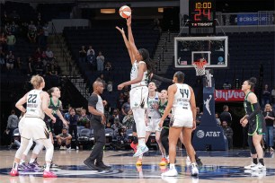 Kayla McBride, Breanna Stewart, and Randall McDaniel playing basketball in a game between Liberty and Lynx