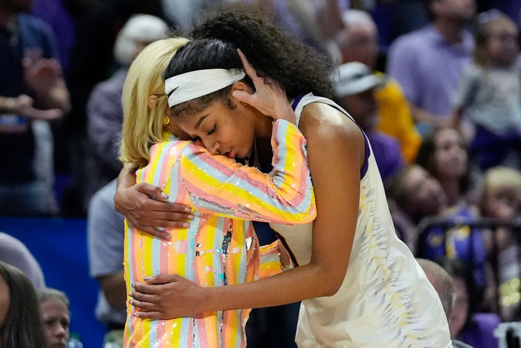 LSU head coach Kim Mulkey hugging forward Angel Reese in celebration during a women's NCAA basketball game