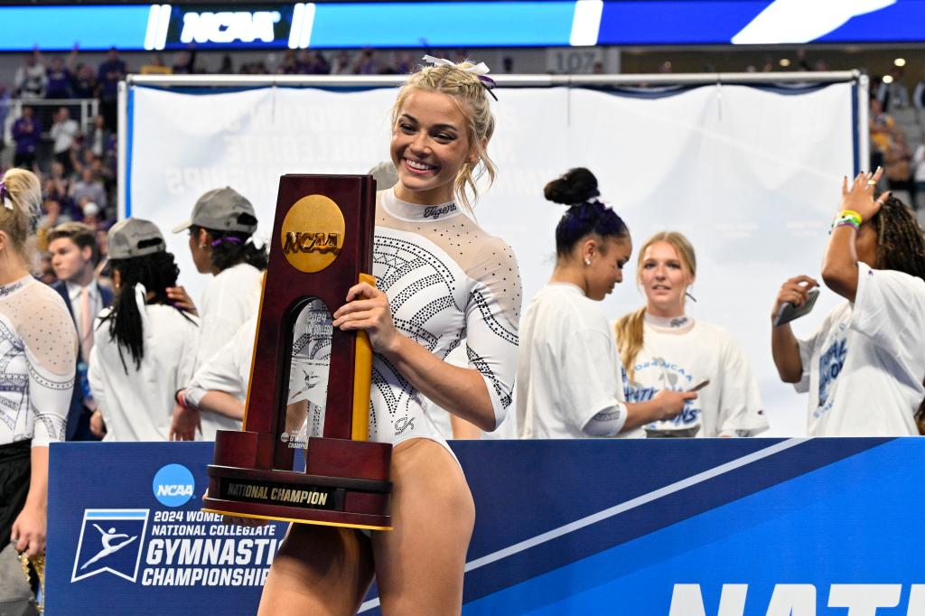 LSU Tigers gymnast Olivia Dunne smiling with the national championship trophy after win at the 2024 Women's National Gymnastics Championship