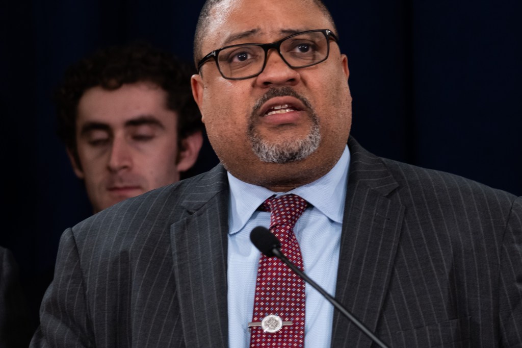 Manhattan District Attorney Alvin Bragg stands with members of his staff at a news conference