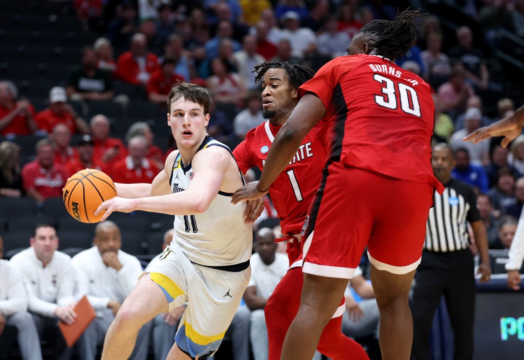 Golden Eagles guard Tyler Kolek (11) drives against North Carolina State Wolfpack guard Jayden Taylor