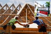 Home under construction and for sale sign