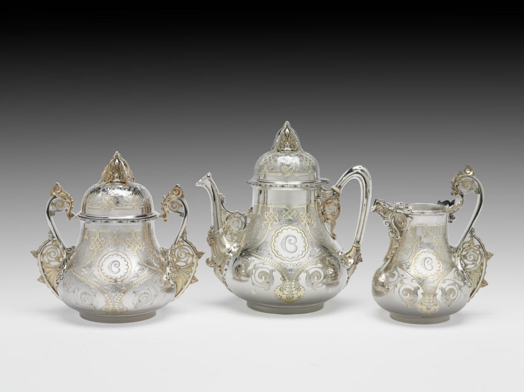 A group of silver teapots on display at the Met Museum, part of the 'Collecting Inspiration: Edward C. Moore at Tiffany & Co.' exhibition.