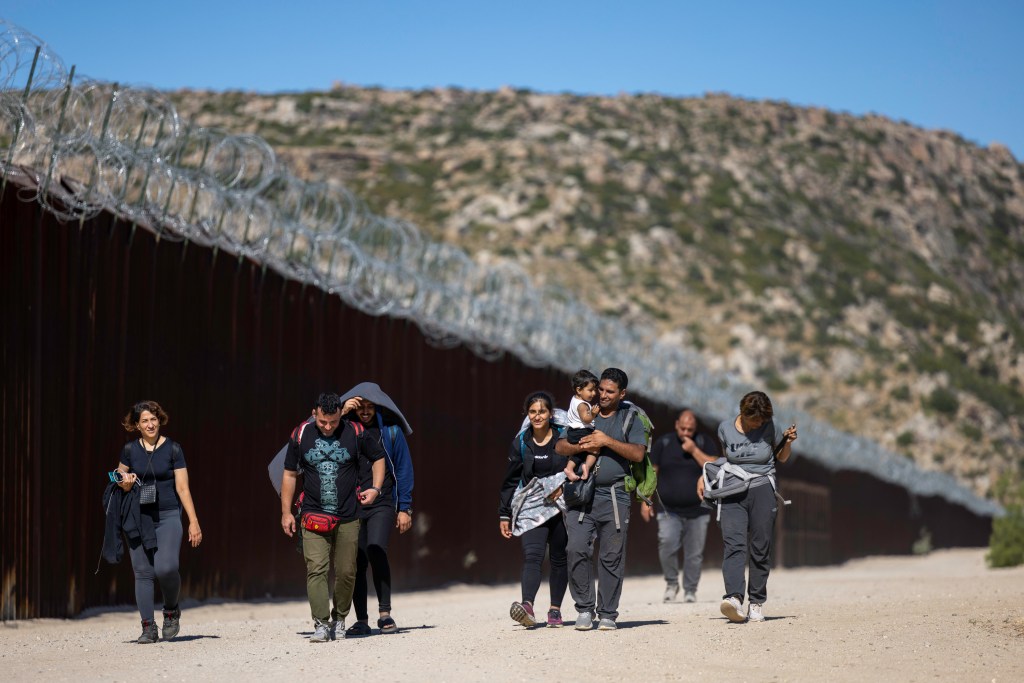 Migrants from around the world continue to arrive across the U.S. southern border near Jacumba Hot Springs, California. After crossing the border from Mexico migrants from countries including Sudan, Mauritania, India, China, Iran as well as many Latin American countries wait for Border Patrol to transport them for processing.