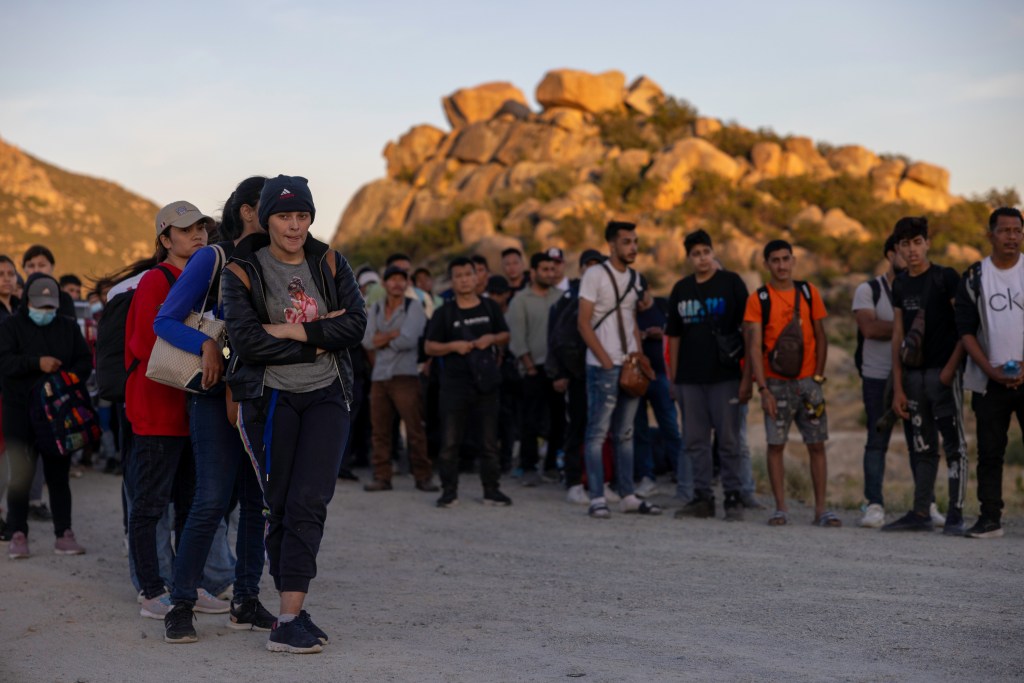 Migrants who crossed the border into Jacumba Hot Springs in California wait for Border Patrol agents to apprehend them.