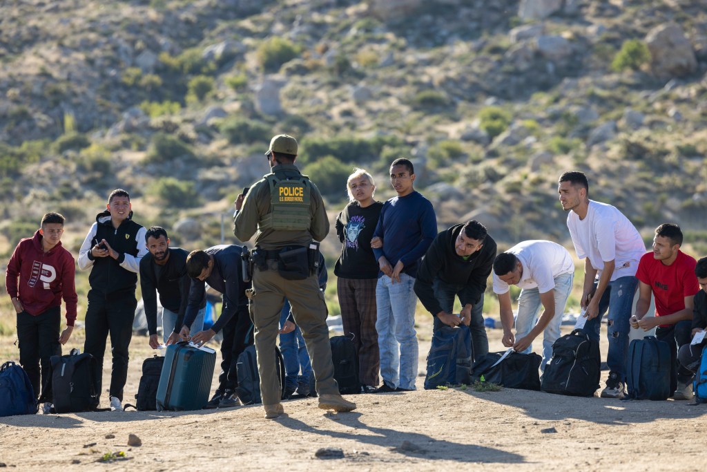 The image above shows migrants waiting to be processed by Border Patrol after crossing into California from Mexico last week.