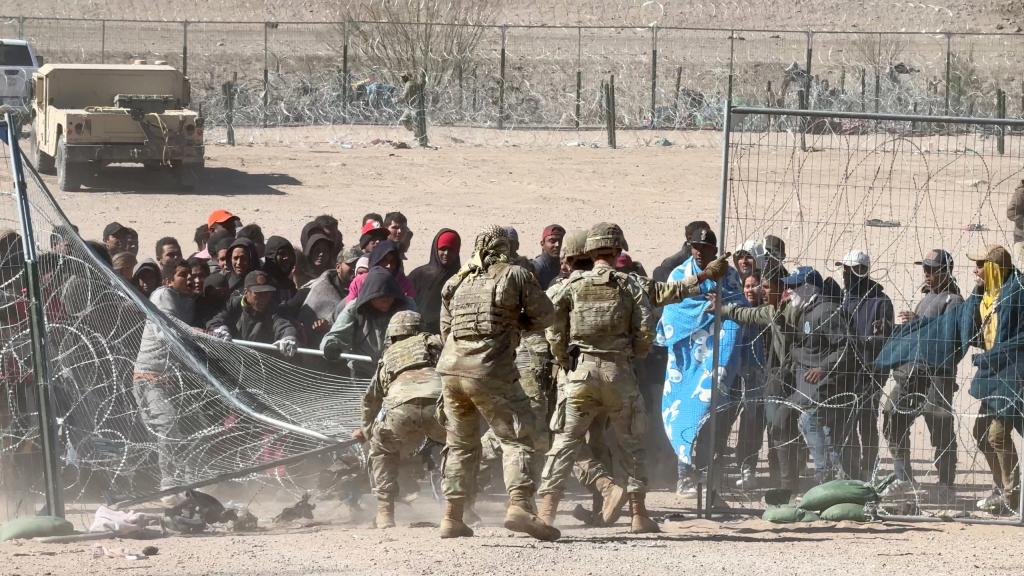 Migrants tear through border wire and overpower national guardsmen deployed to the border by the State of Texas.