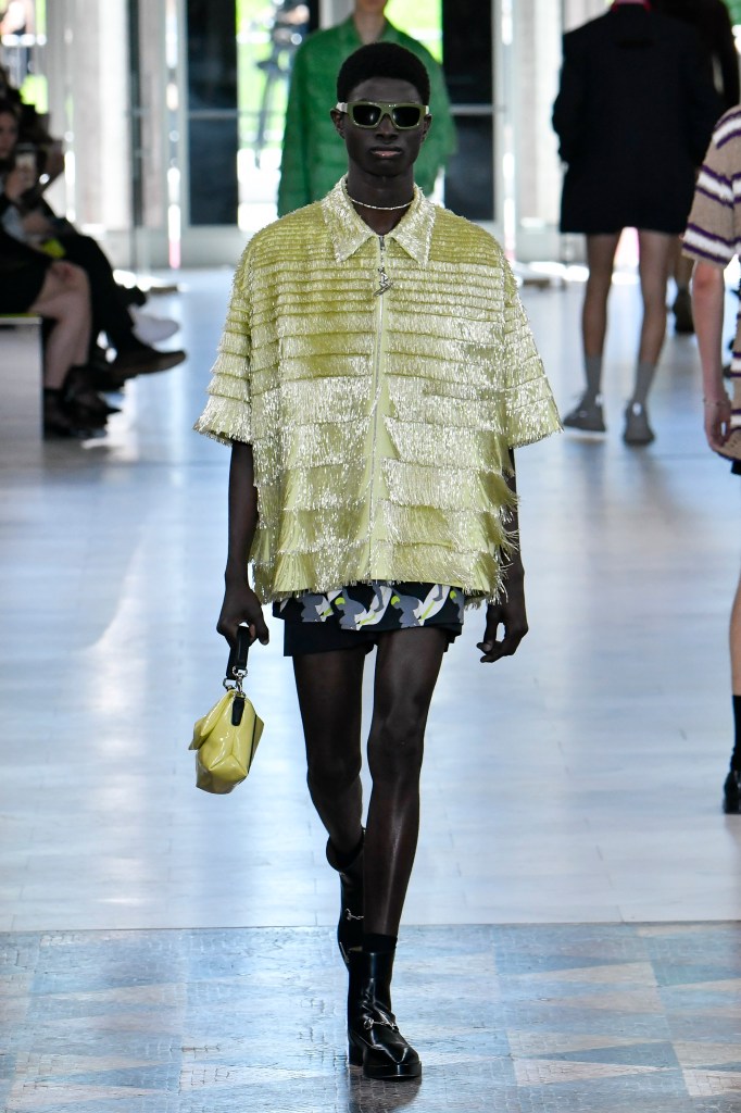 A model walking down the Milan Fashion Week runway sporting colorful mini shorts as part of Gucci's Spring/Summer 2025 collection