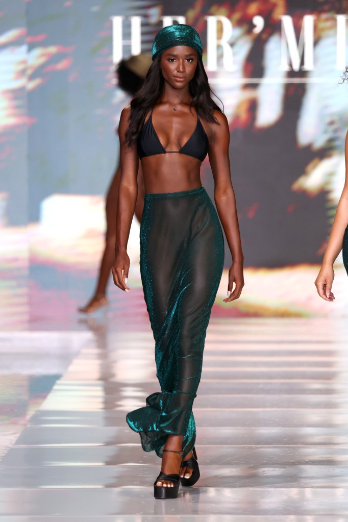 A model walking the runway for Hermine Swim at Miami Swim Week, wearing a swimsuit, on SLS South Beach