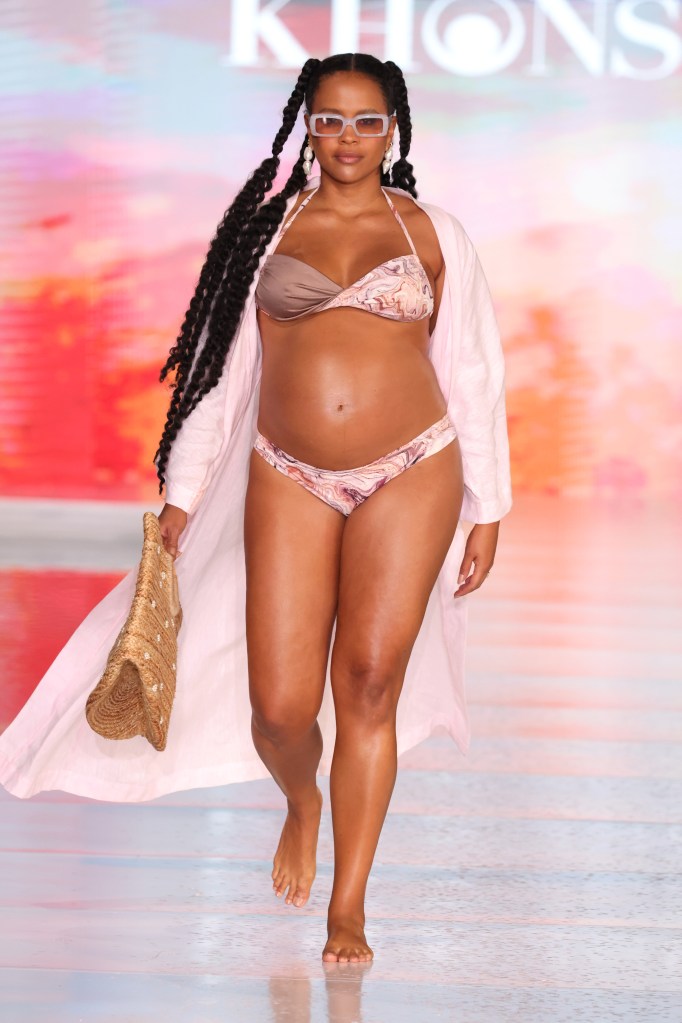 A model wearing Khonsu Swim attire walking down the runway at Miami Swim Week in South Beach, June 2024