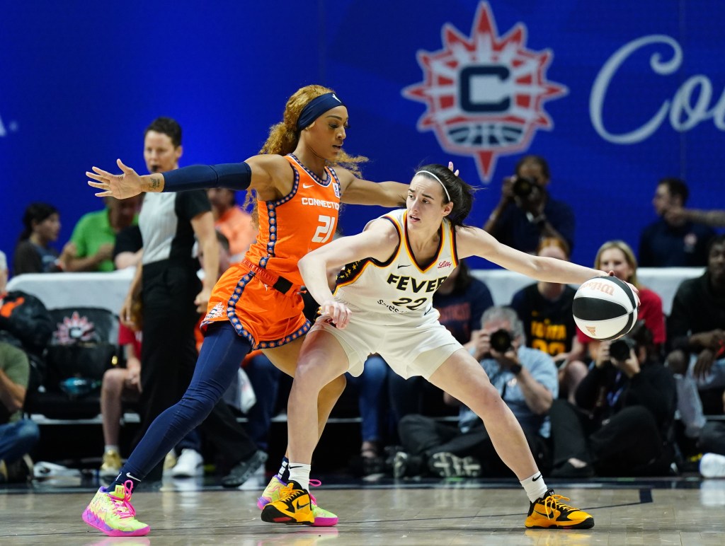 Indiana Fever guard Caitlin Clark (22) moves the ball against Connecticut Sun guard DiJonai Carrington (21) in the first quarter at Mohegan Sun Arena on June 10, 2024. 