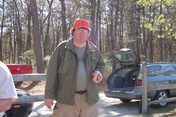 A man, Rex Heuermann, standing outside with a can of soda around the time of the Gilgo Beach killings