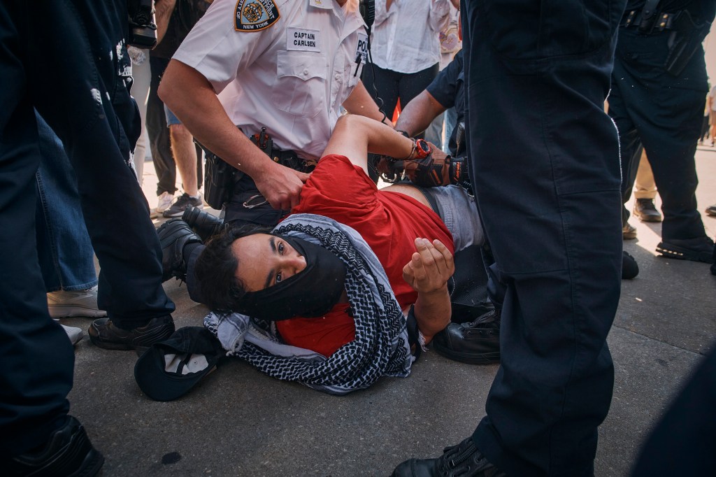 New York City police officers detain a pro-Palestinian demonstrator
