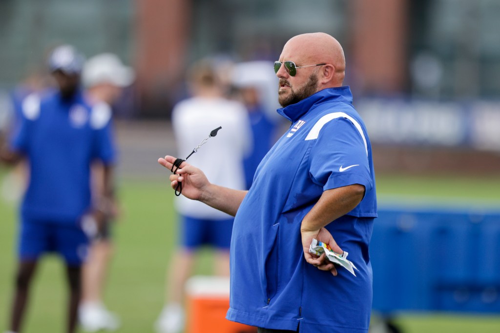 New York Giants head coach Brian Daboll, in a blue shirt, at 2022 training camp in East Rutherford, NJ