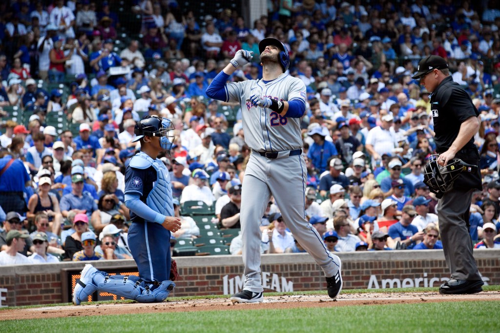  Mets designated hitter J.D. Martinez looks towards the sky as he crosses home plate after hitting a three-run home run in the first inning of a baseball game against the Chicago Cubs.