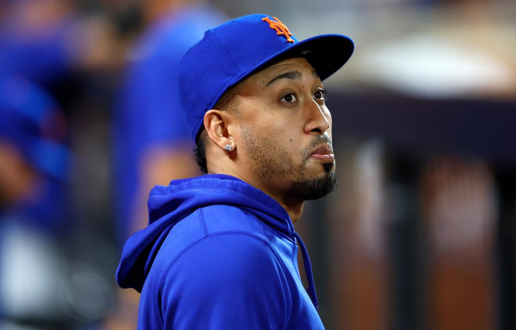 New York Mets player Edwin Diaz looking out from the dugout during a baseball game against the Miami Marlins