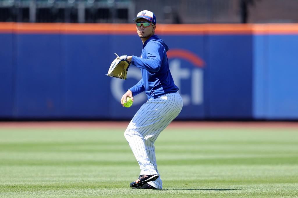 Injured New York Mets starting pitcher, Kodai Senga, throwing a softball in the outfield before a game against the Arizona Diamondbacks at Citi Field