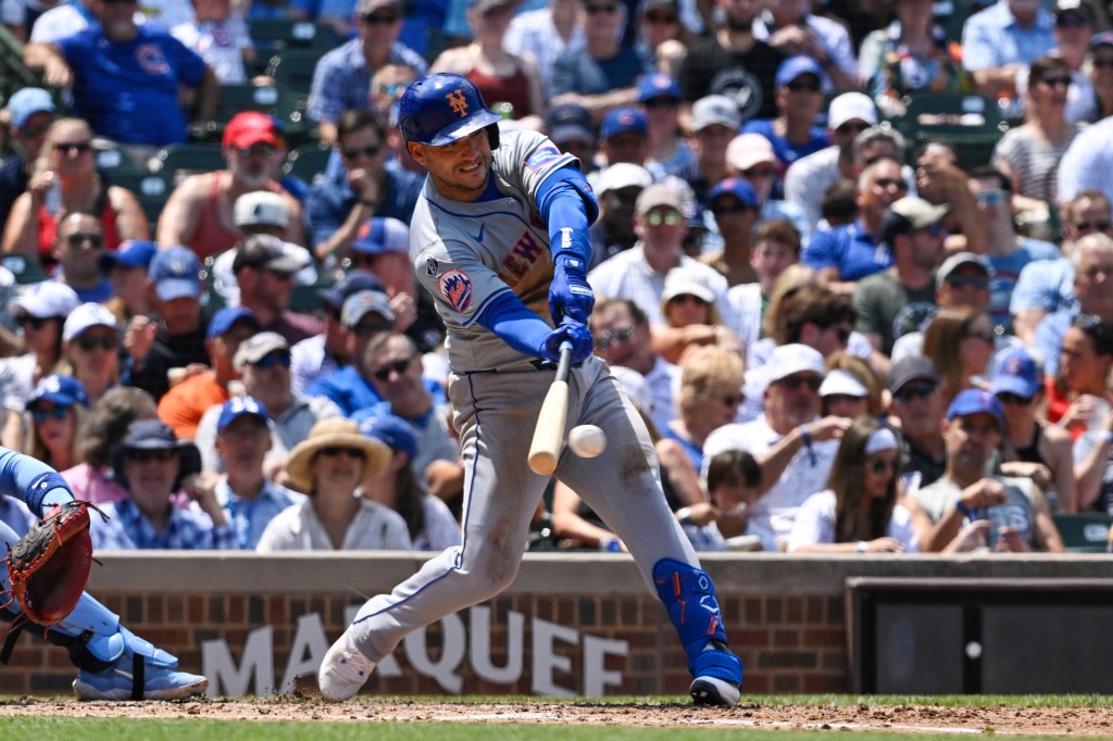 Jose Iglesias of the New York Mets hitting an RBI single during a game against the Chicago Cubs.