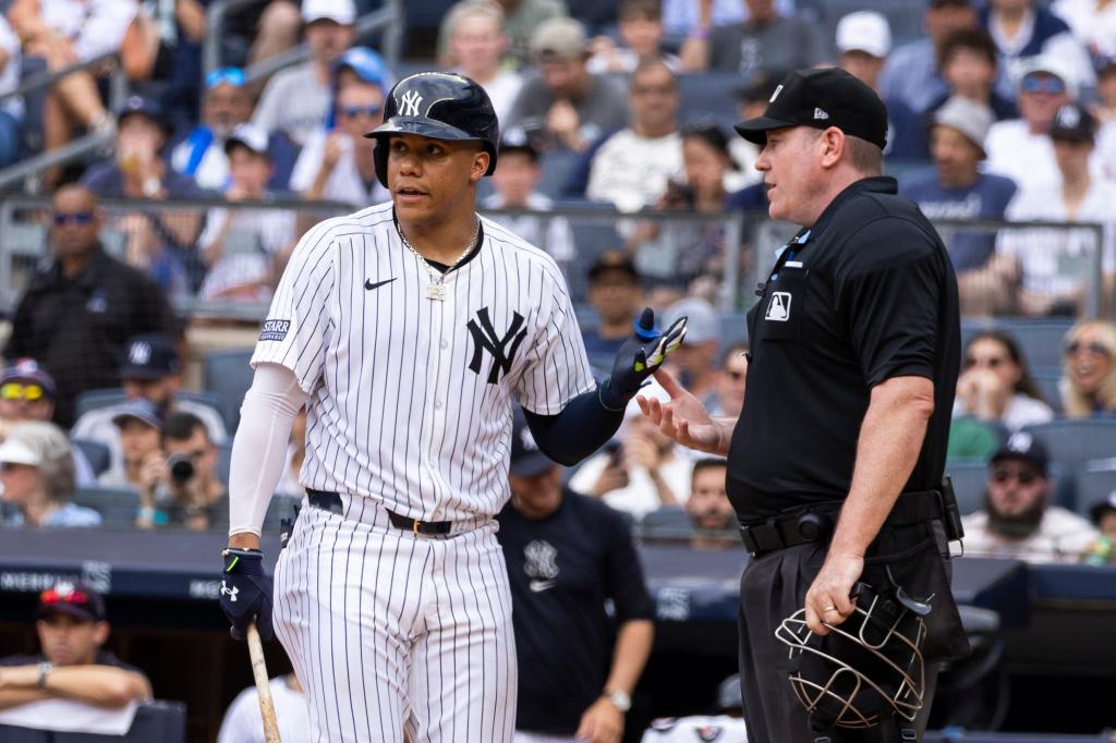 New York Yankees outfielder, Juan Soto, arguing a strike call in the eighth inning against the Atlanta Braves at Yankee Stadium with umpire in the background