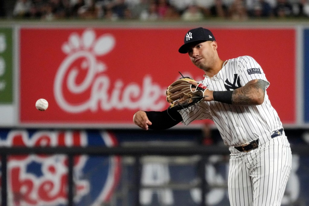 Yankees second baseman Gleyber Torres throws the ball to first baseman Ben Rice to ground out Baltimore Orioles' Cedric Mullins during the sixth inning of a baseball game.