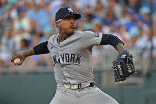 New York Yankees starting pitcher Marcus Stroman, number 0, delivering a pitch during a game against the Kansas City Royals at Kauffman Stadium on June 11, 2024.