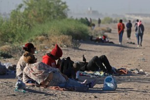 Migrants laying on the ground