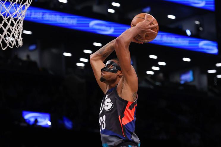 Nets center Nic Claxton throws down a dunk.