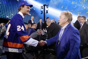 Jesse Pulkkinen shakes the hand of David Conte after being selected 54th overall by the Islanders in the second round of the 2024 NHL Draft.
