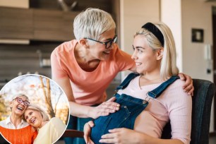 A woman touching a pregnant woman's belly