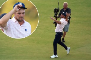 Bryson DeChambeau, who has a three-shot lead, throws a signed golf ball to the crowd after completing his third round at the U.S. Open.