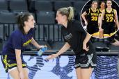 Former Iowa Hawkeyes teammates Caitlin Clark (L) #22 of the Indiana Fever and Kate Martin #20 of the Las Vegas Aces greet each other on the court during warmups before their game at Michelob ULTRA Arena on May 25, 2024 in Las Vegas, Nevada.