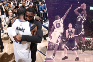 Mavericks assistant God Shammgod, who was a star player at Providence (right), hugs Kyrie Irving after Dallas' Game 3 win over the Timberwolves in the Western Conference Finals.