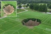 Terrifying moment sinkhole swallows up soccer field